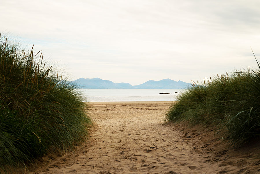 Llanddwyn Beach sand dunes with Snowdonia in the distance