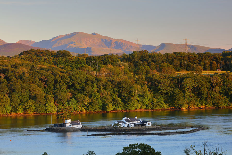 View of the Menai Straits with Snowdonia mountains in the distance.