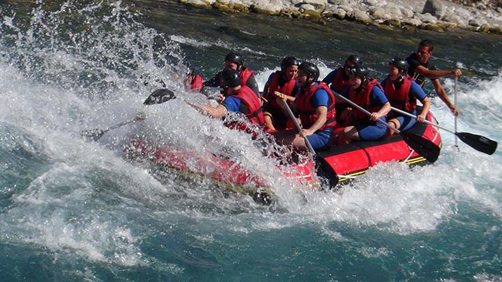 people white water rafting on the river